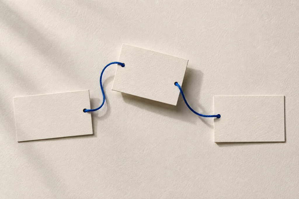 Three blank paper cards connected by a blue cord.
