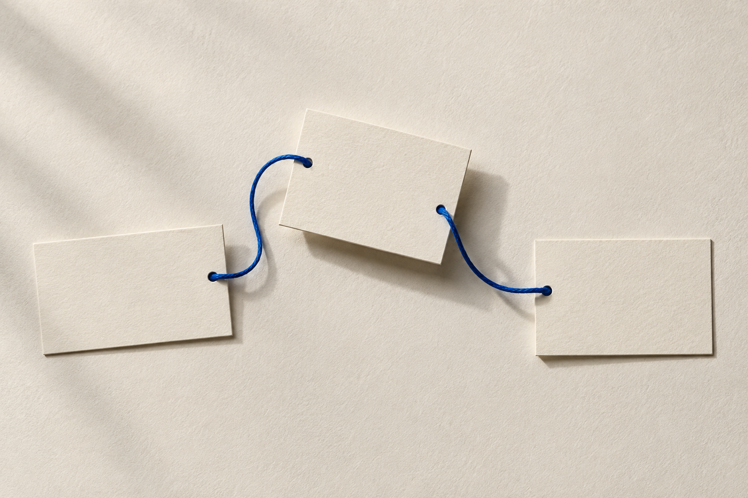 Three blank paper cards connected by a blue cord.